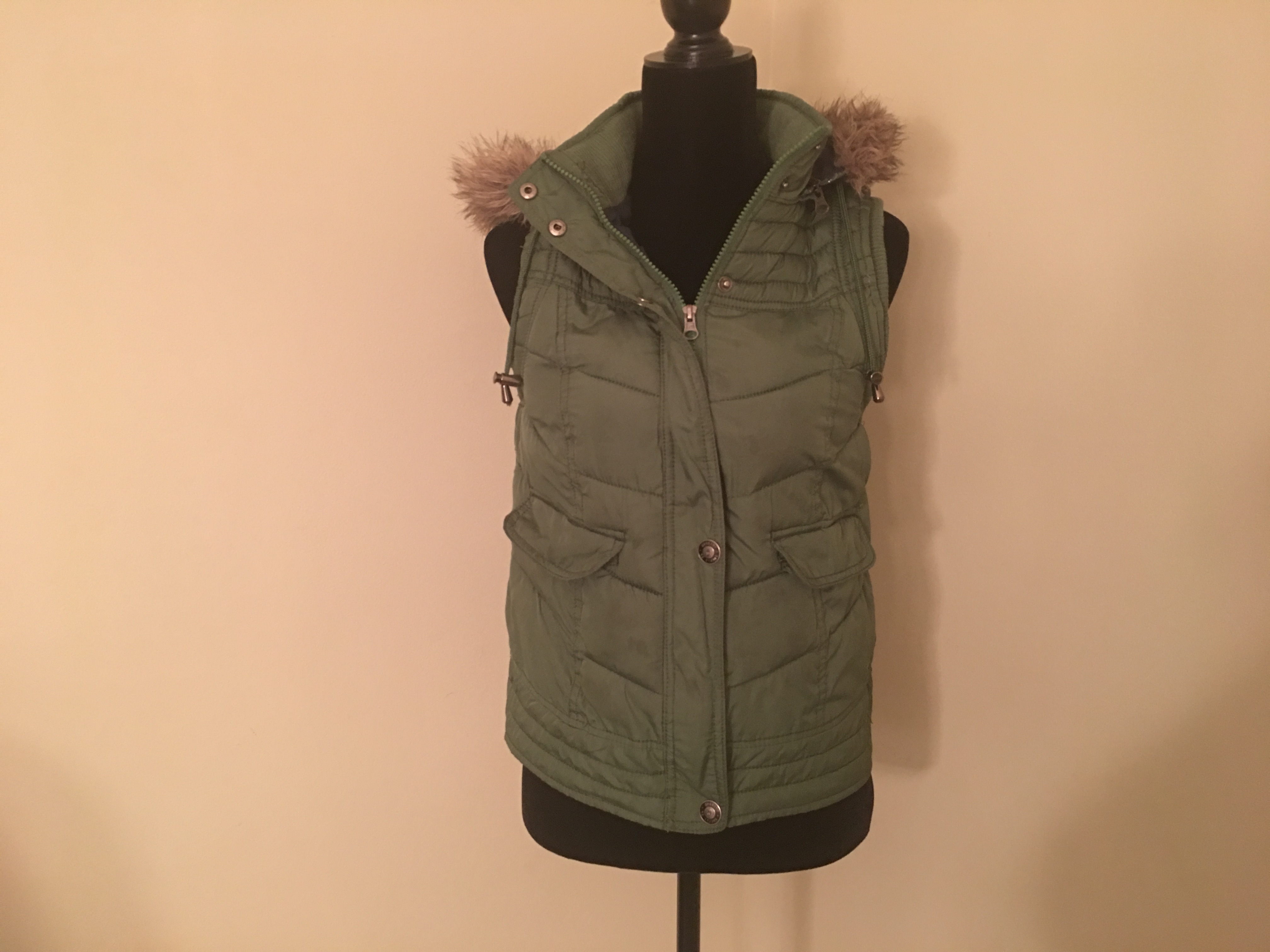 green vest with fur hood